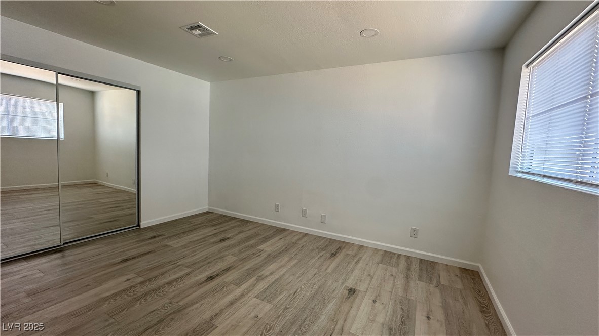 5108 Greene Lane, Unit D Las Vegas, NV 89119 - Photo 13 of 16 Unfurnished bedroom with light wood finished floors and a closet