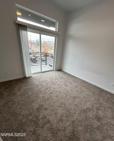 an empty room with large windows