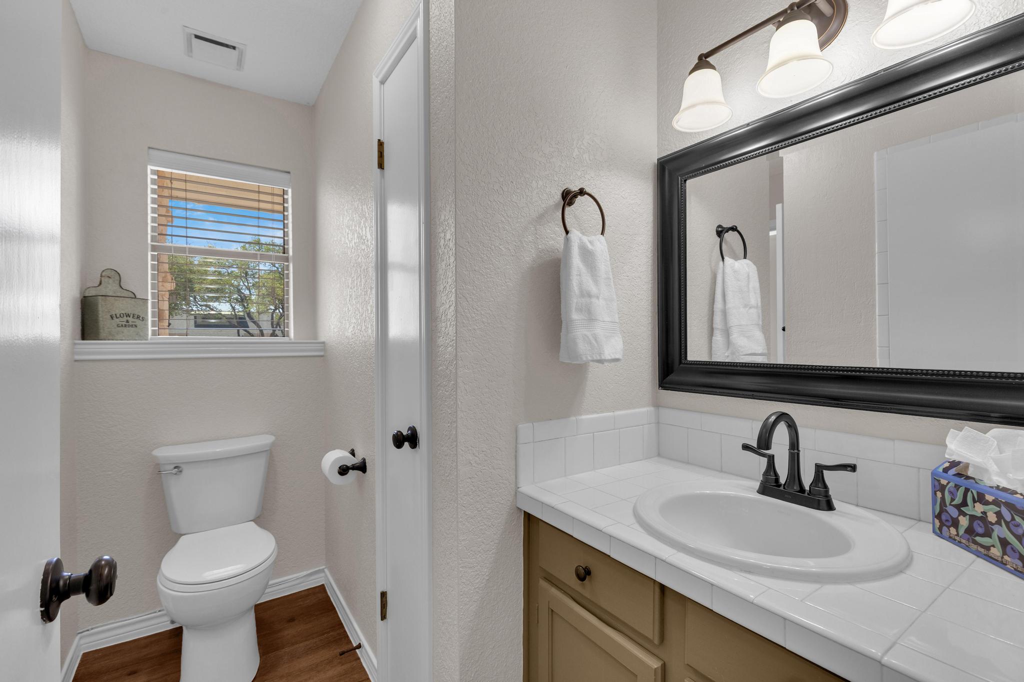 7902 Bar K Ranch Road Lago Vista, TX 78645 - Photo 17 of 35 Bathroom featuring vanity, a textured wall, and dark wood-style flooring