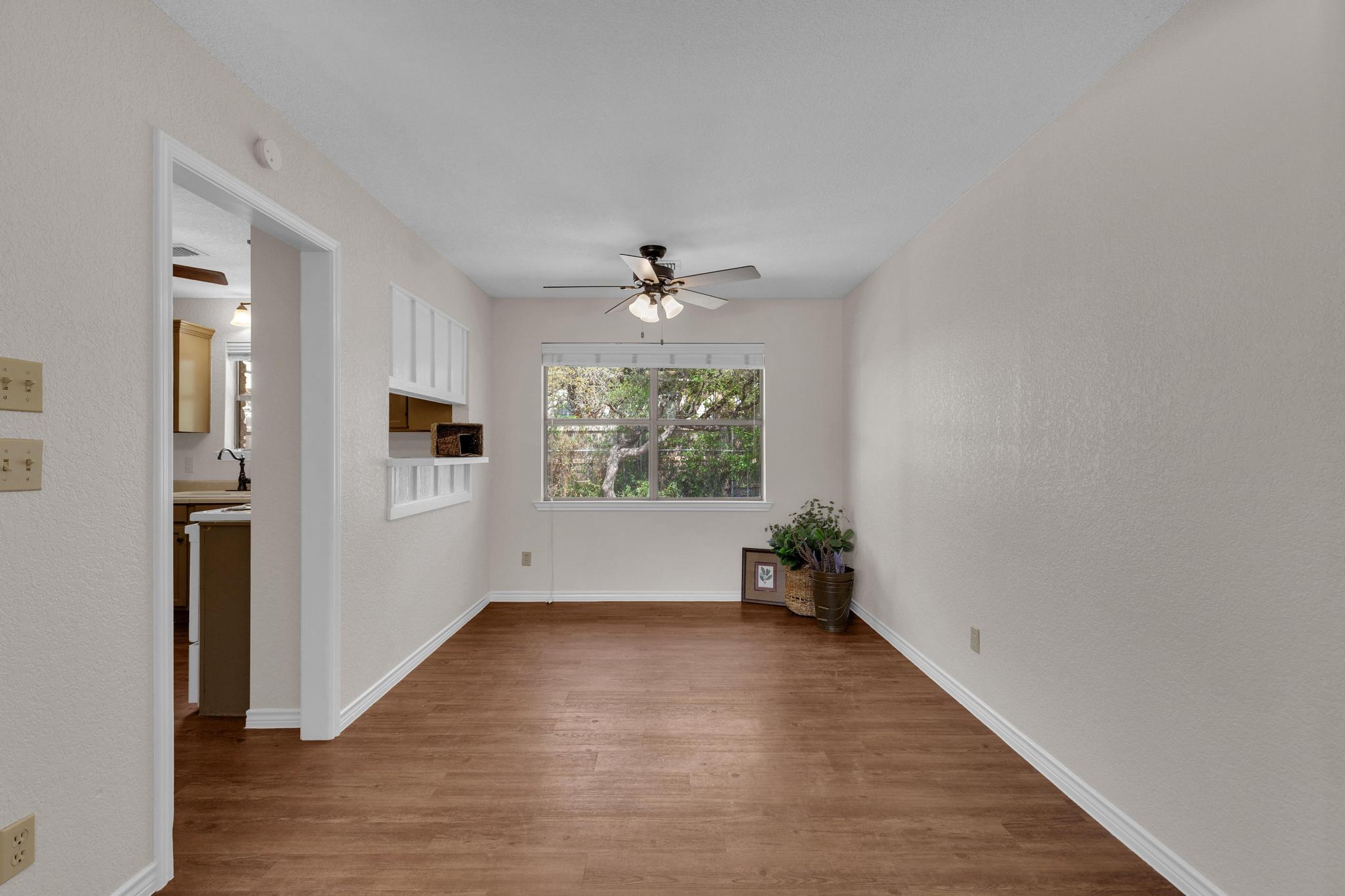7902 Bar K Ranch Road Lago Vista, TX 78645 - Photo 8 of 35 Spare room with a ceiling fan and dark wood finished floors