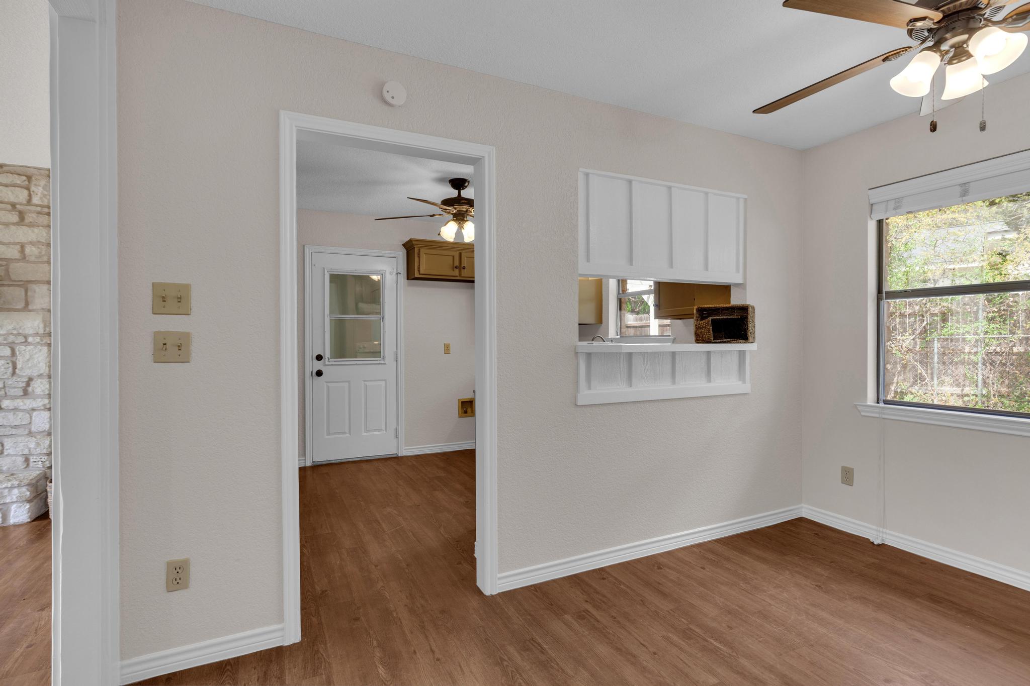 7902 Bar K Ranch Road Lago Vista, TX 78645 - Photo 10 of 35 Kitchen with a ceiling fan, wood finished floors, and healthy amount of natural light