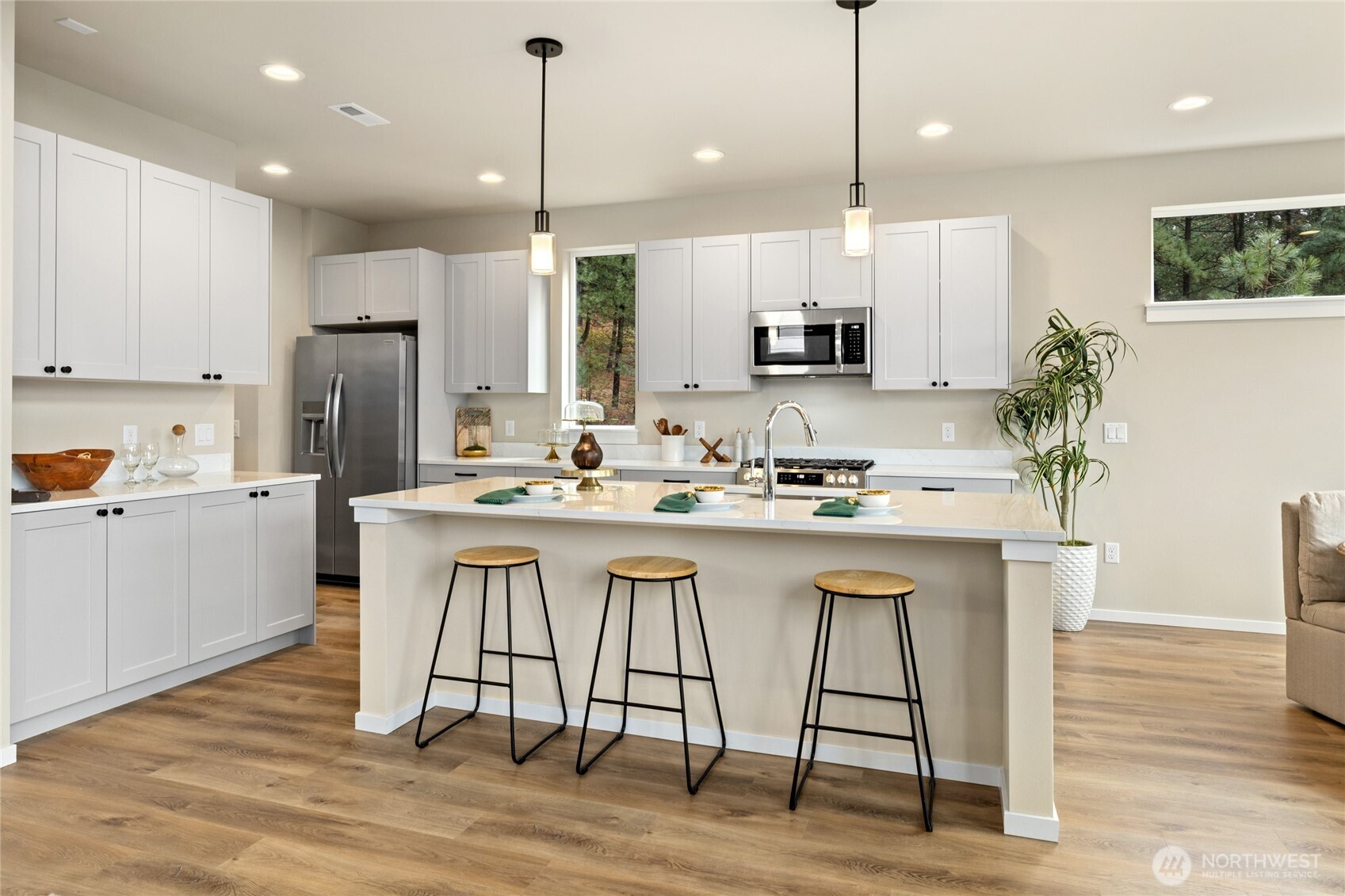 403 Outfitter Place Cle Elum, WA 98922 - Photo 10 of 28 a kitchen with stainless steel appliances kitchen island granite countertop a dining table chairs sink and cabinets