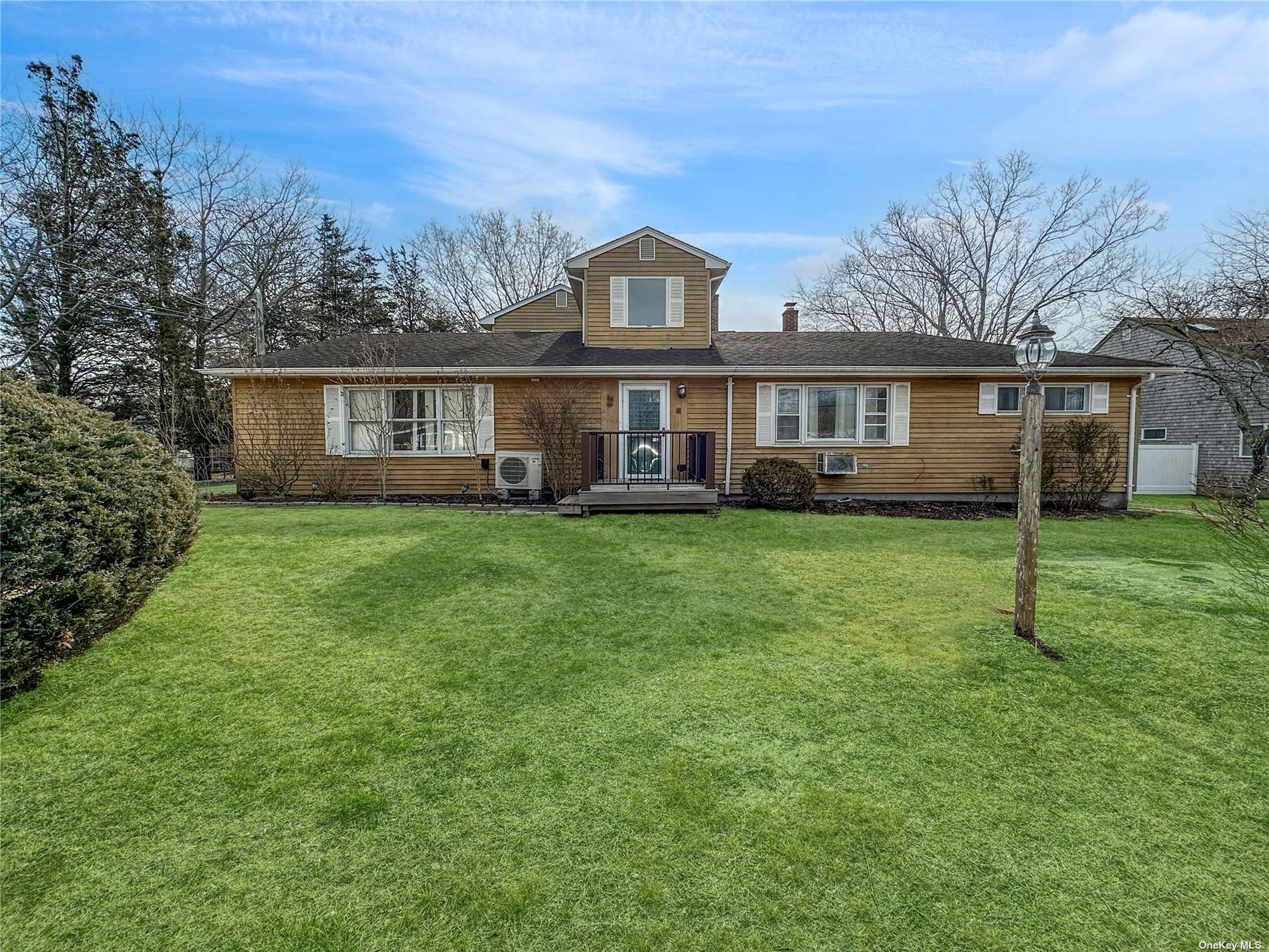 8 Lincoln Road Hampton Bays, NY 11946 - Photo 1 of 1 front view of a house with a yard