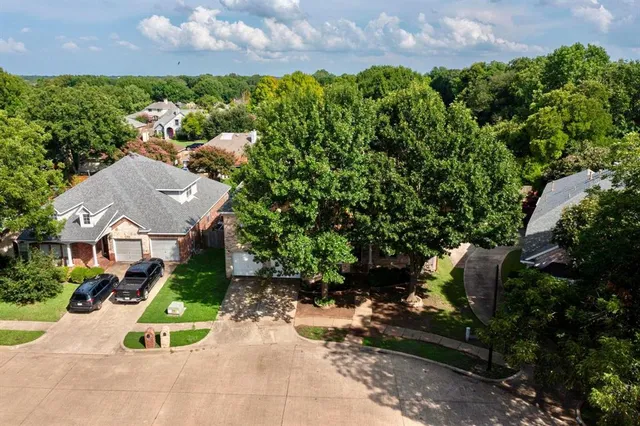 an aerial view of a house with a yard and lake view