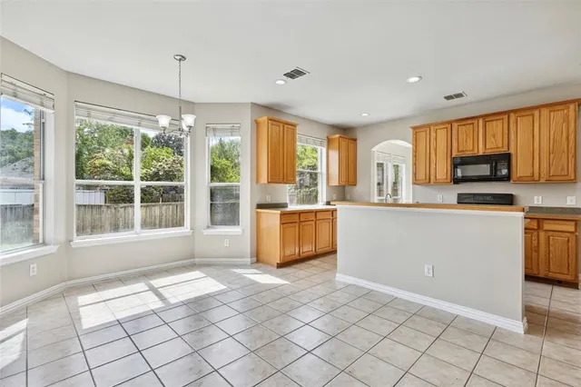 a kitchen with a sink a counter top space and stainless steel appliances