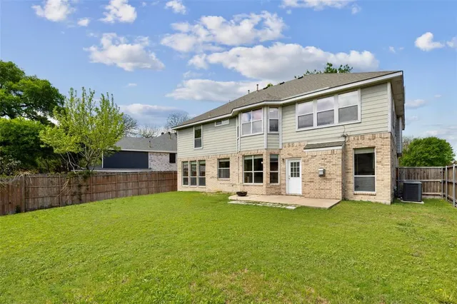 a front view of house with yard and swimming pool