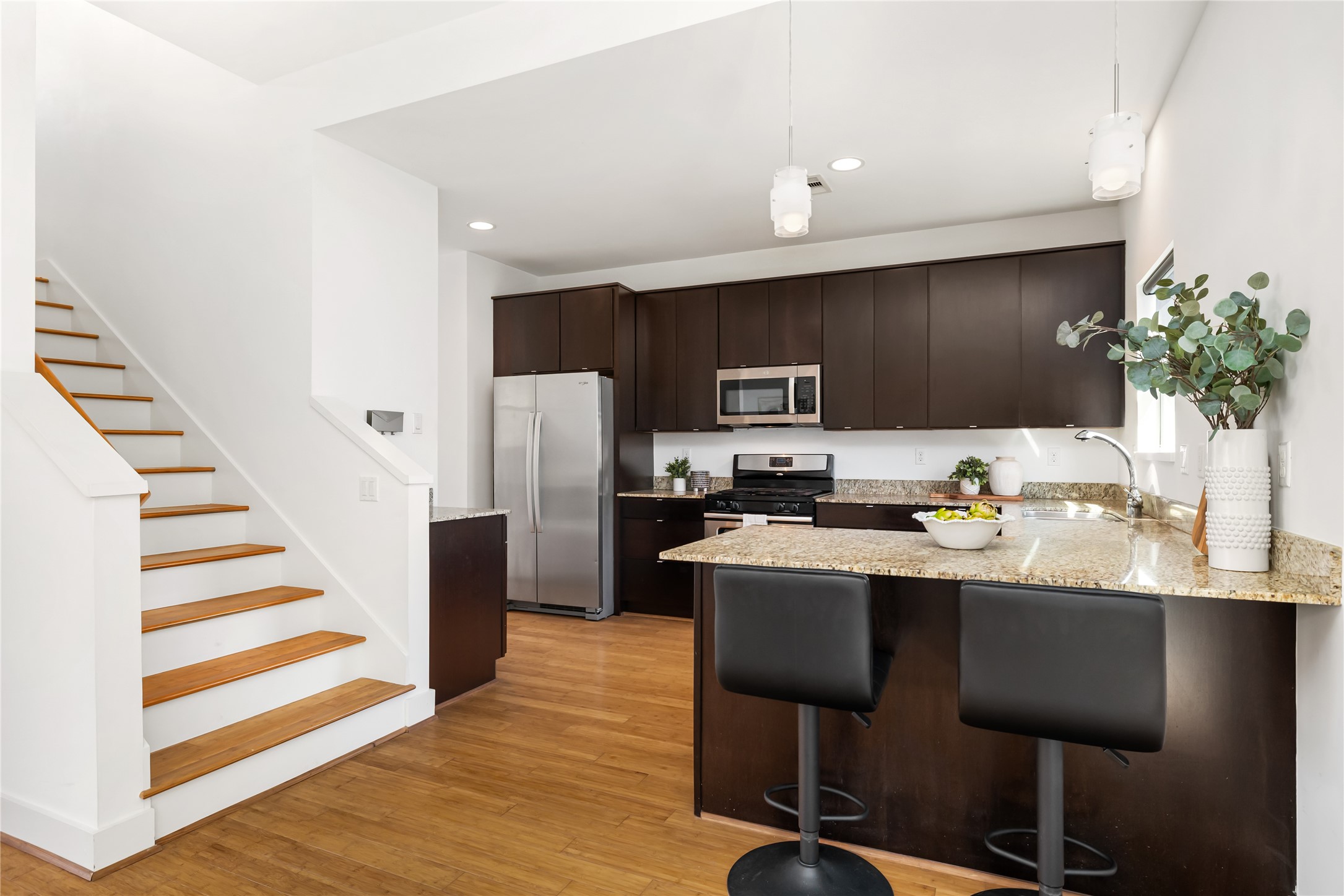 5012 Cornish Street Houston, TX 77007 - Photo 23 of 38 a kitchen with stainless steel appliances kitchen island granite countertop a refrigerator and a stove top oven