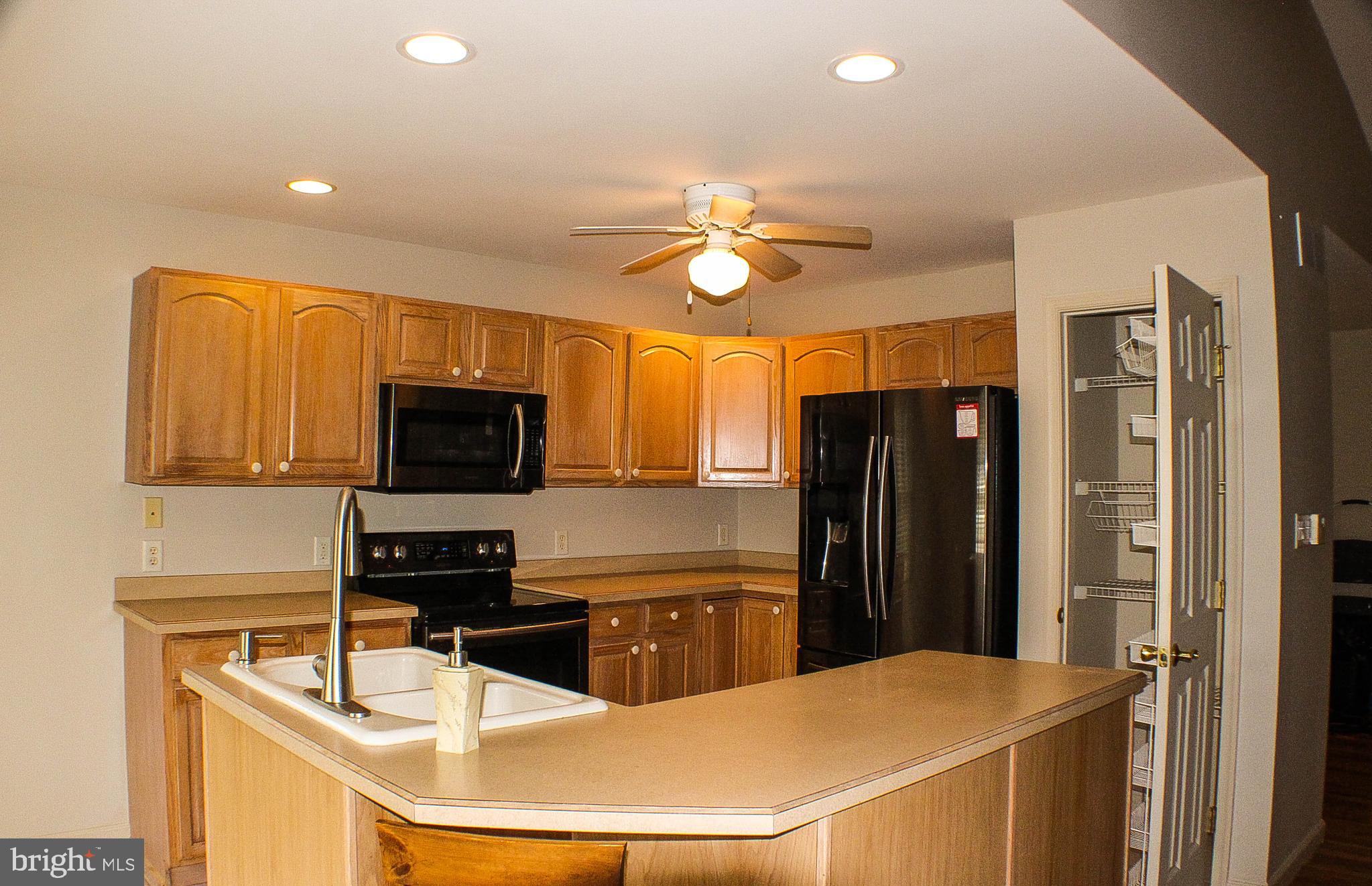 187 North Planters Lane Dover, DE 19901 - Photo 12 of 28 a kitchen with stainless steel appliances a refrigerator a stove a sink a refrigerator dining table and chairs
