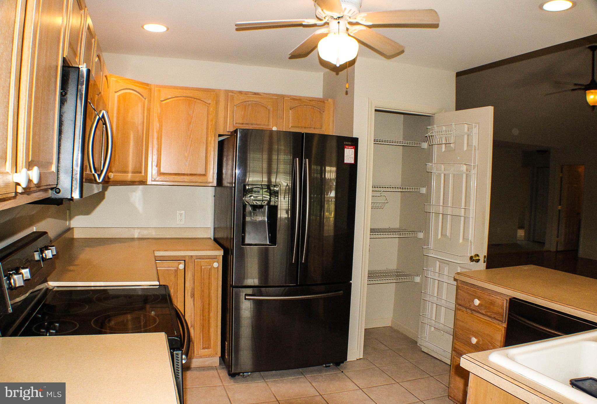 187 North Planters Lane Dover, DE 19901 - Photo 13 of 28 a kitchen with stainless steel appliances a refrigerator and a stove top oven