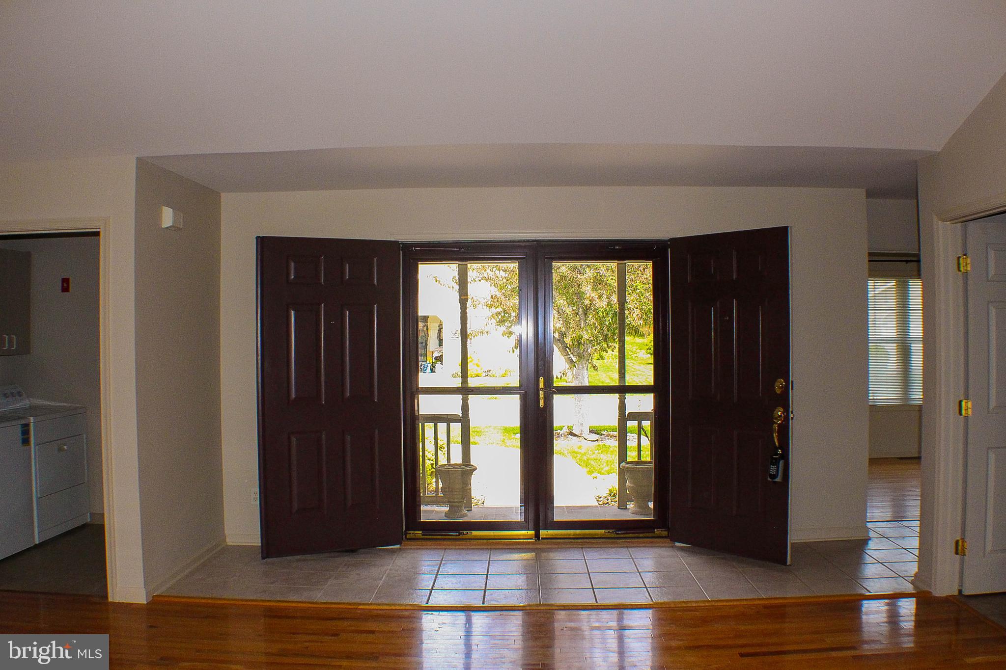187 North Planters Lane Dover, DE 19901 - Photo 8 of 28 a view of an empty room with wooden floor and a window