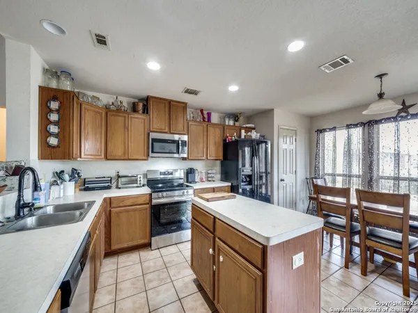 a kitchen with a stove sink and refrigerator