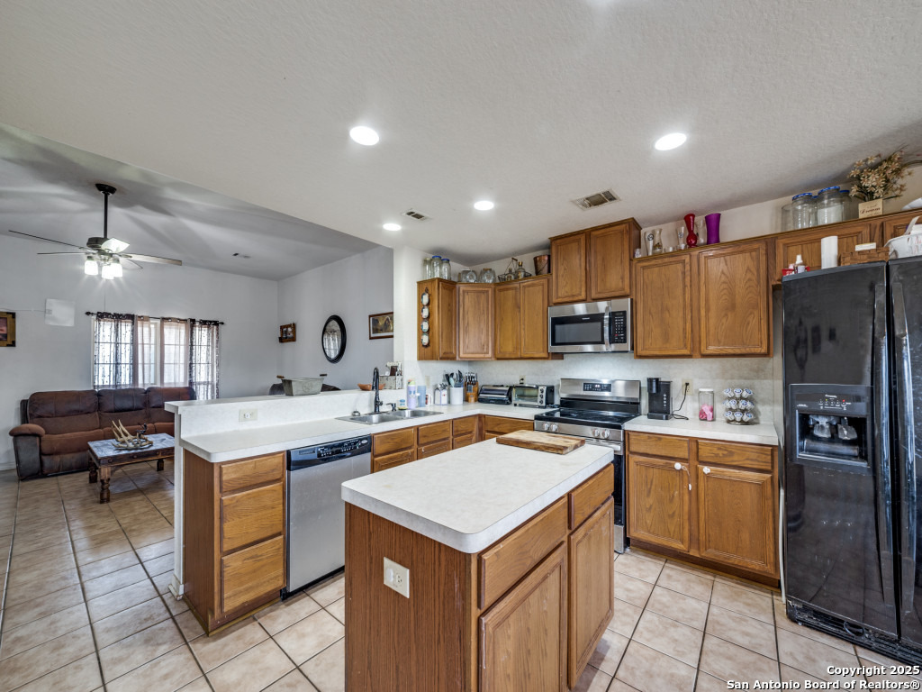 4979 Farm To Market Road 1343 Devine, TX 78016 - Photo 8 of 27 a kitchen that has a lot of cabinets in it and stainless steel appliances
