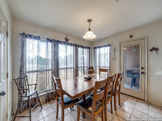 a view of a dining room with furniture and window