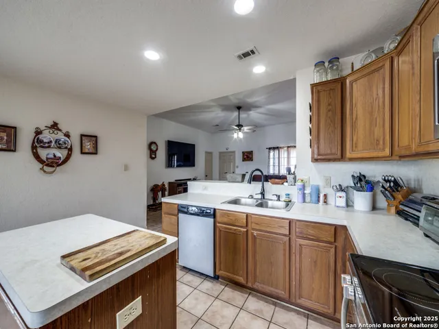 a kitchen with a sink a stove and cabinets