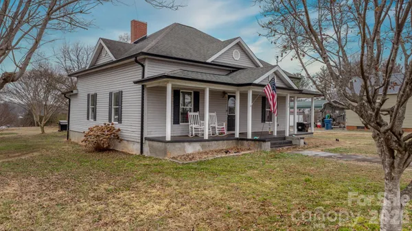 a view of a house with patio and a yard