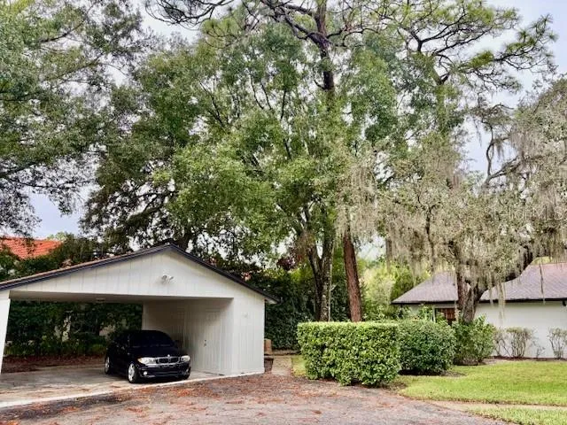 a car parked in front of house with a yard