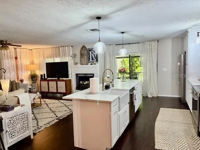 a open kitchen with stainless steel appliances granite countertop a sink stove and refrigerator