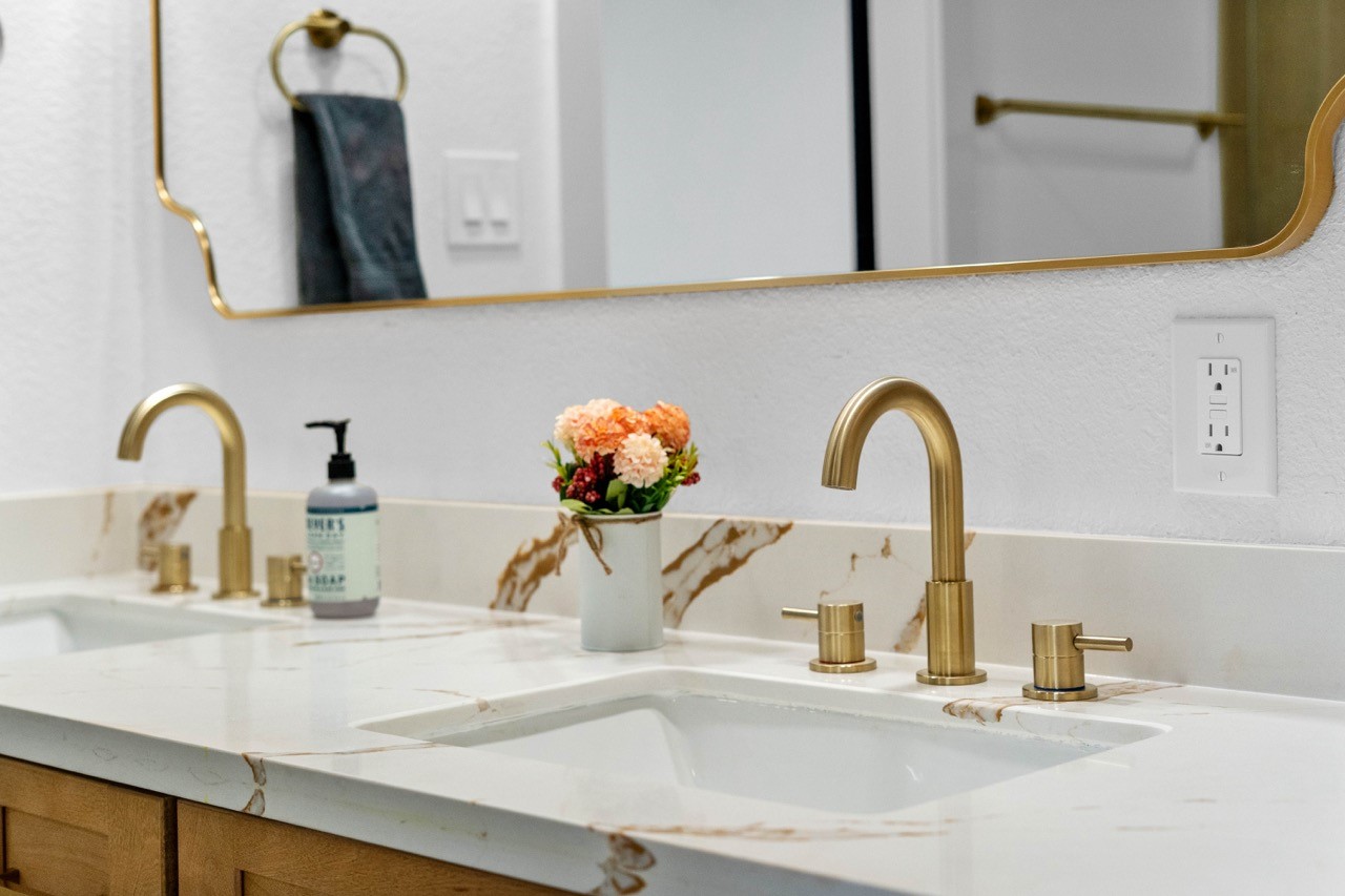 5326 Findlay Drive Pasadena, TX 77505 - Photo 35 of 50 Designer dual vanity showcases elegant brushed gold faucets, quartz countertops, and modern finishes.