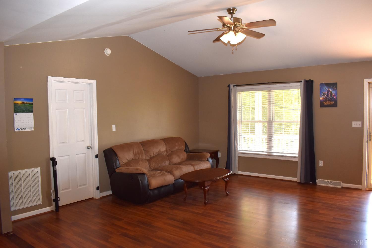 1389 Hummingbird Lane Spout Spring, VA 24593 - Photo 18 of 31 a living room with furniture and a wooden floor