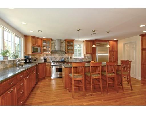 855 Boston Post Road Weston, MA 02493 - Photo 4 of 18 a kitchen with stainless steel appliances kitchen island granite countertop a stove a sink a dining table and chairs