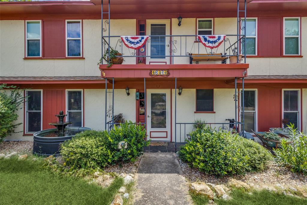 16777 John Wiley Road Justin, TX 76247 - Photo 6 of 16 a view of a brick building with many windows and potted plants