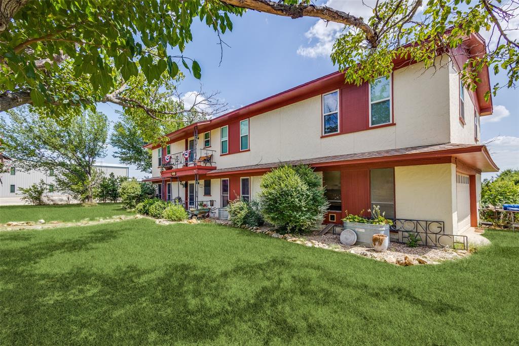 16777 John Wiley Road Justin, TX 76247 - Photo 7 of 16 a backyard of a house with table and chairs plants and large tree