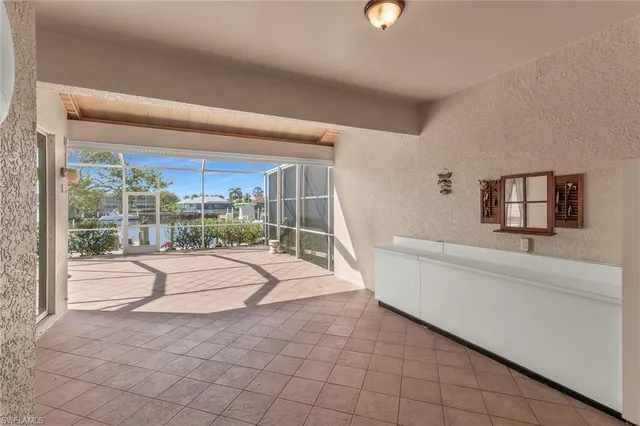 a view of an empty room with closet and windows