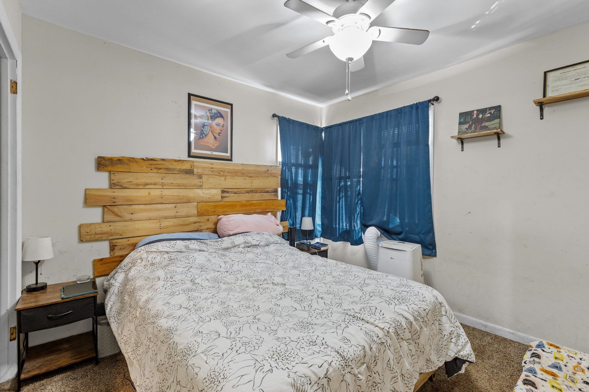 3605 Buzzard Road Wendell, NC 27591 - Photo 13 of 25 a bedroom with a bed and wooden floor