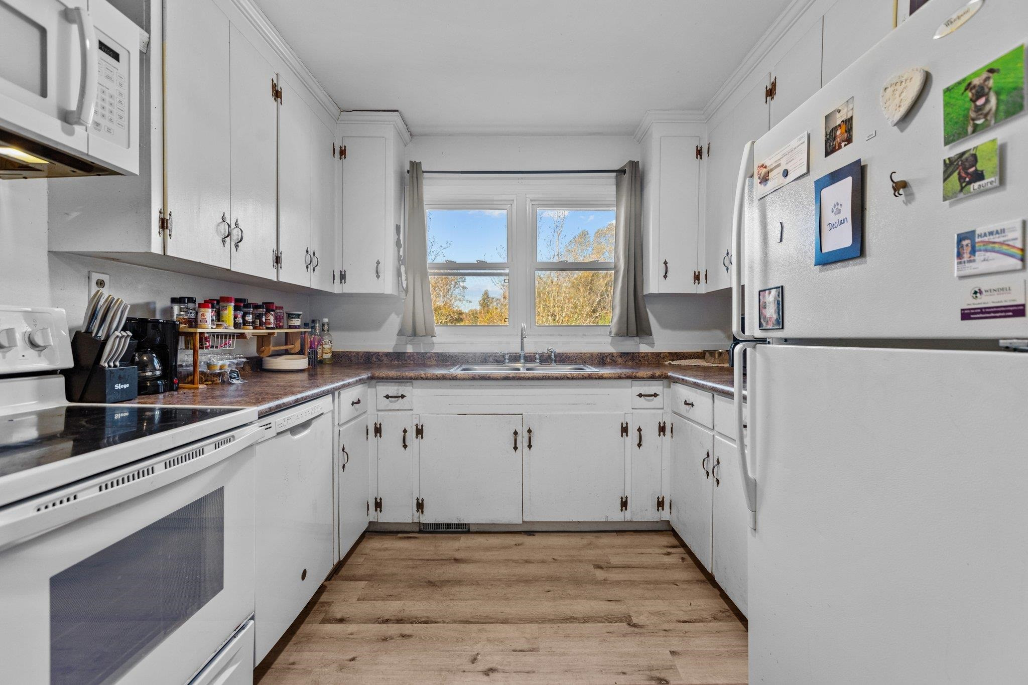 3605 Buzzard Road Wendell, NC 27591 - Photo 5 of 25 a kitchen with granite countertop white cabinets and white appliances