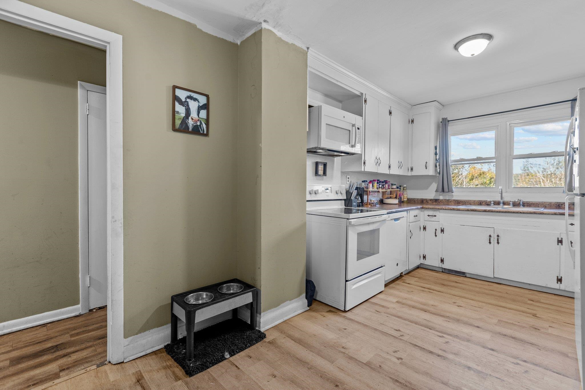 3605 Buzzard Road Wendell, NC 27591 - Photo 7 of 25 a kitchen with white cabinets and white appliances