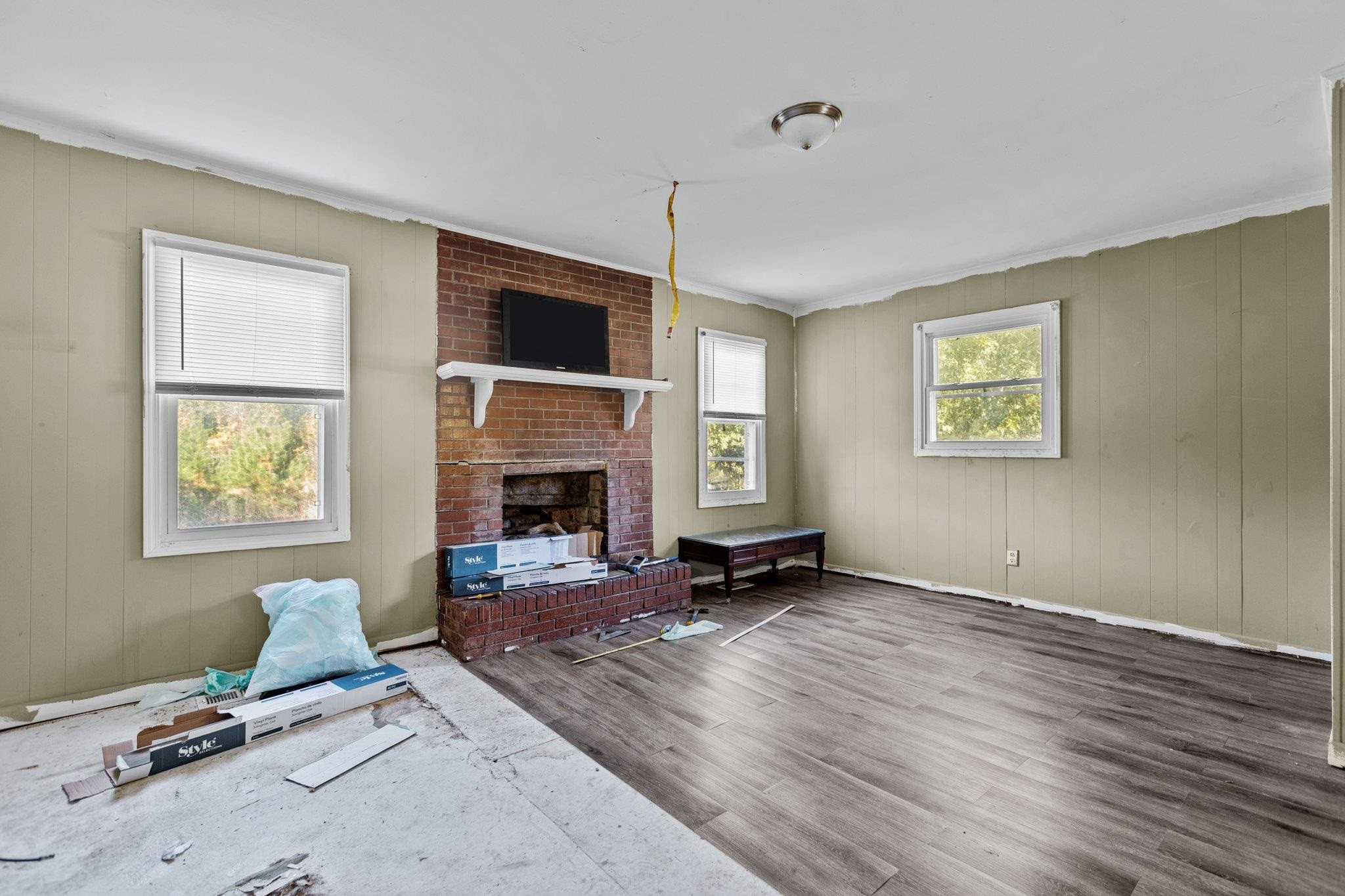 3605 Buzzard Road Wendell, NC 27591 - Photo 8 of 25 a living room with furniture flat screen tv and a fireplace