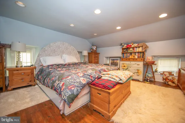 a spacious bedroom with a bed and a chandelier