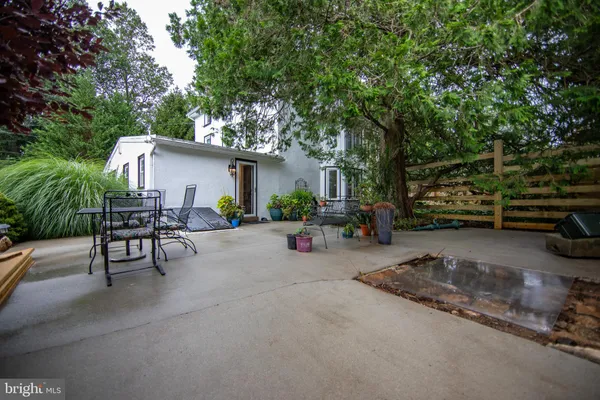 a view of backyard with outdoor seating and trees