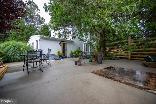 a view of backyard with outdoor seating and trees