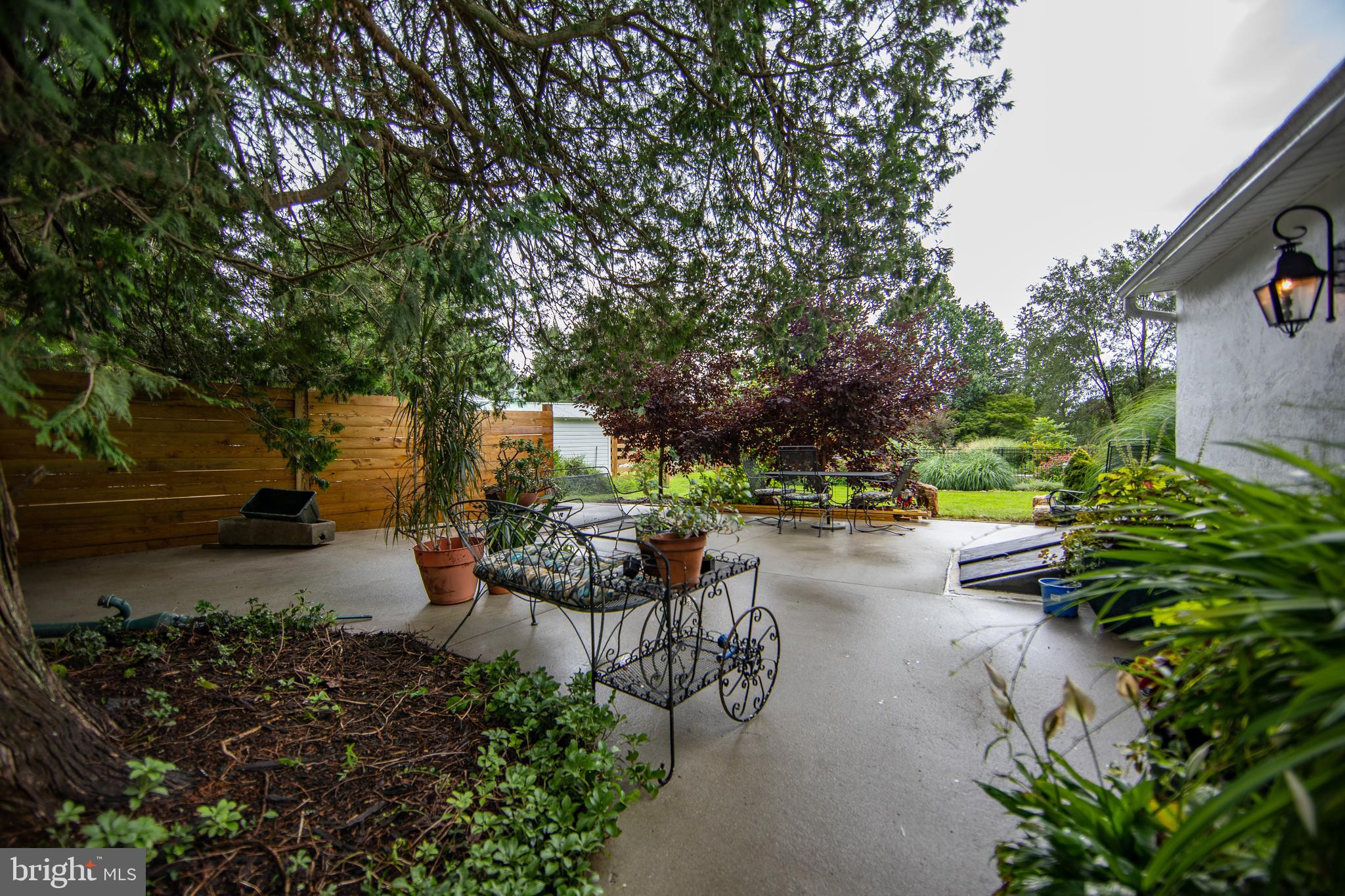 4 Seminary Road Glenmoore, PA 19343 - Photo 19 of 35 a view of a patio with table and chairs potted plants and large tree