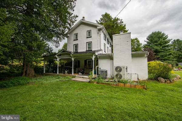 a front view of house with yard and outdoor seating