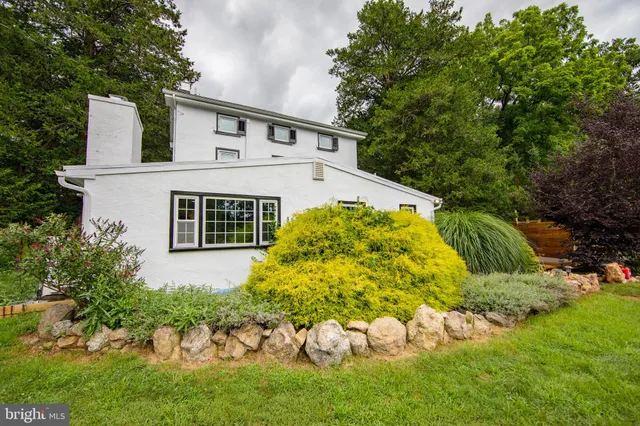 a view of a house with a yard and garden