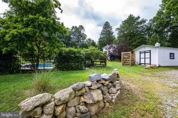 a view of a house with backyard porch and sitting area