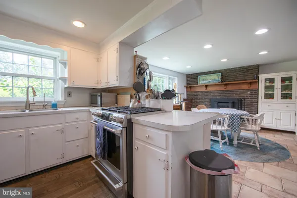 a kitchen with a stove a sink and a refrigerator