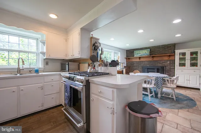 a kitchen with a stove a sink and a refrigerator