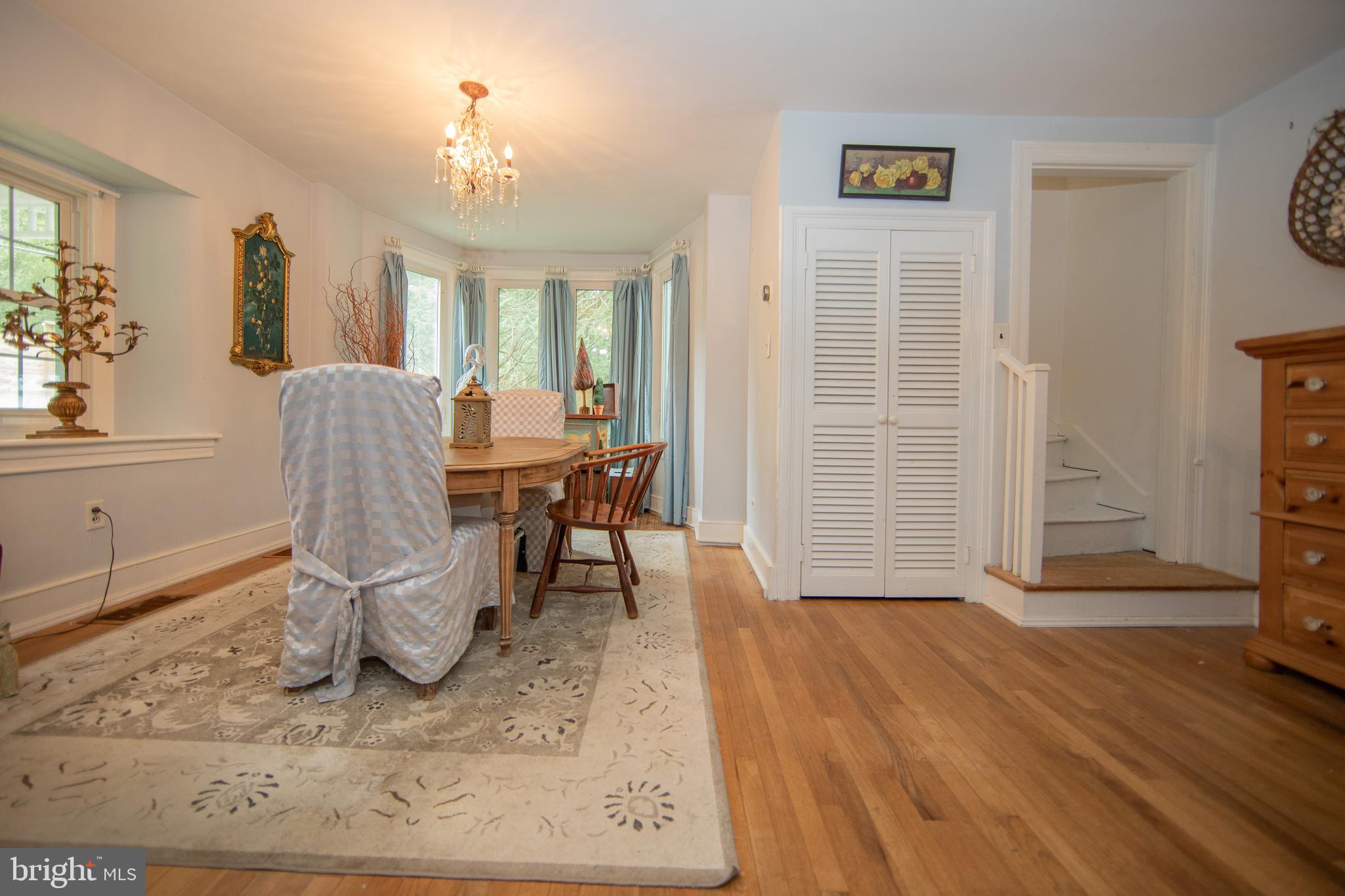 4 Seminary Road Glenmoore, PA 19343 - Photo 9 of 35 a dining room with wooden floor and a chandelier
