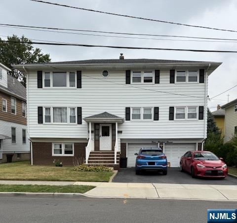 a couple of cars parked in front of a house