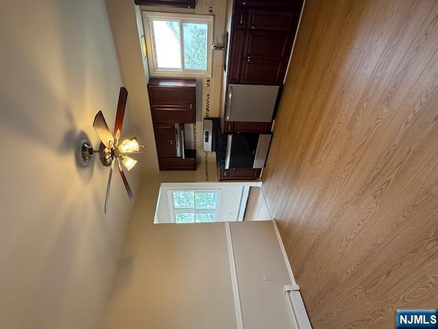 911 York Street, Unit 2 East Rutherford, NJ 07073 - Photo 5 of 12 a view of kitchen with granite countertop cabinets stainless steel appliances and a flat screen tv