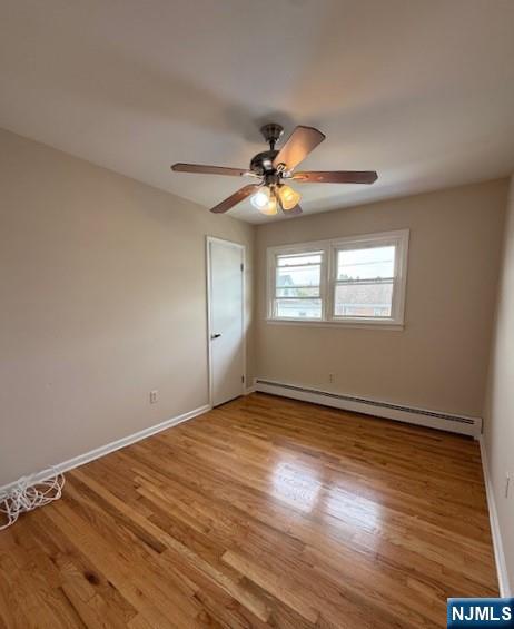 911 York Street, Unit 2 East Rutherford, NJ 07073 - Photo 9 of 12 a view of an empty room with window and wooden floor