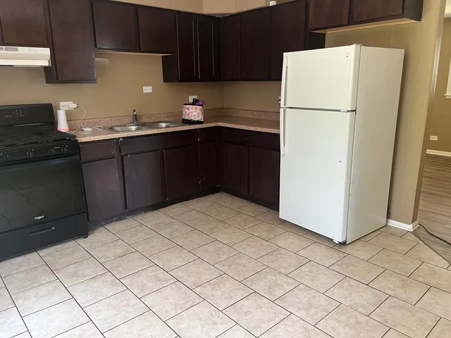 a kitchen with a sink appliances and cabinets
