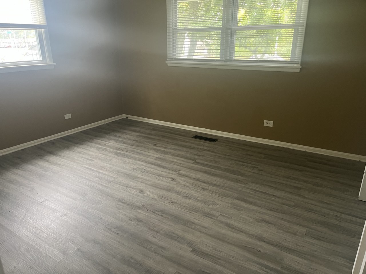 4741 183rd Street Country Club Hills, IL 60478 - Photo 8 of 18 an empty room with wooden floor and windows