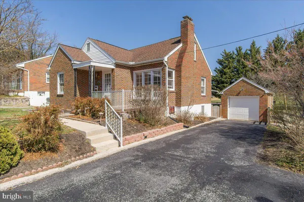 a view of a house with a yard and pathway