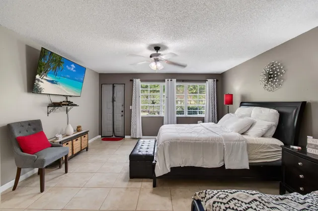 a bedroom with a bed and a flat screen tv