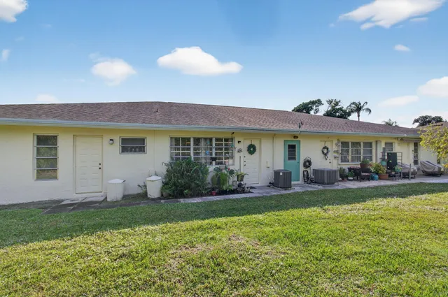 a view of a house with a yard porch and sitting area