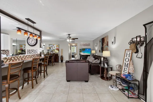 a living room with lots of furniture and fan